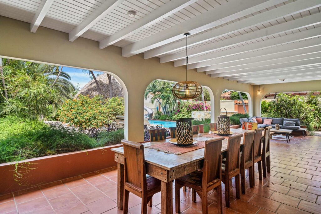 Covered outdoor dining area overlooking the Villa Nirvana garden