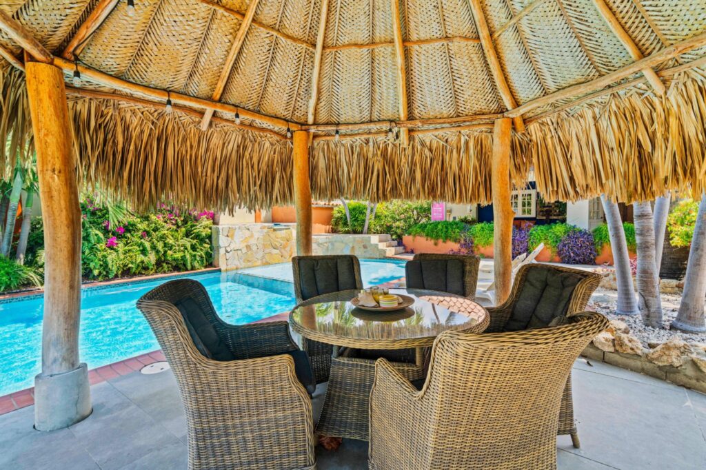 Shaded palapa seating beside the Villa Nirvana pool