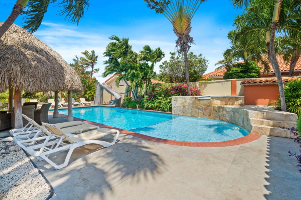 Sun loungers beside the private pool and palapa at Villa Nirvana