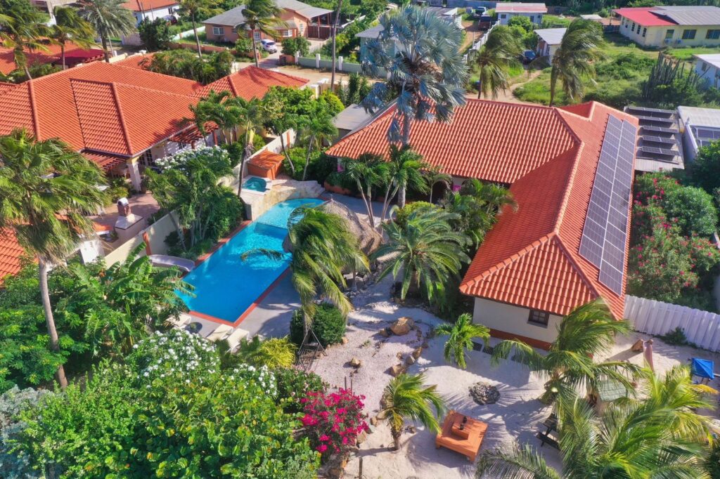 Aerial view of Villa Nirvana pool and tropical garden in Noord, Aruba