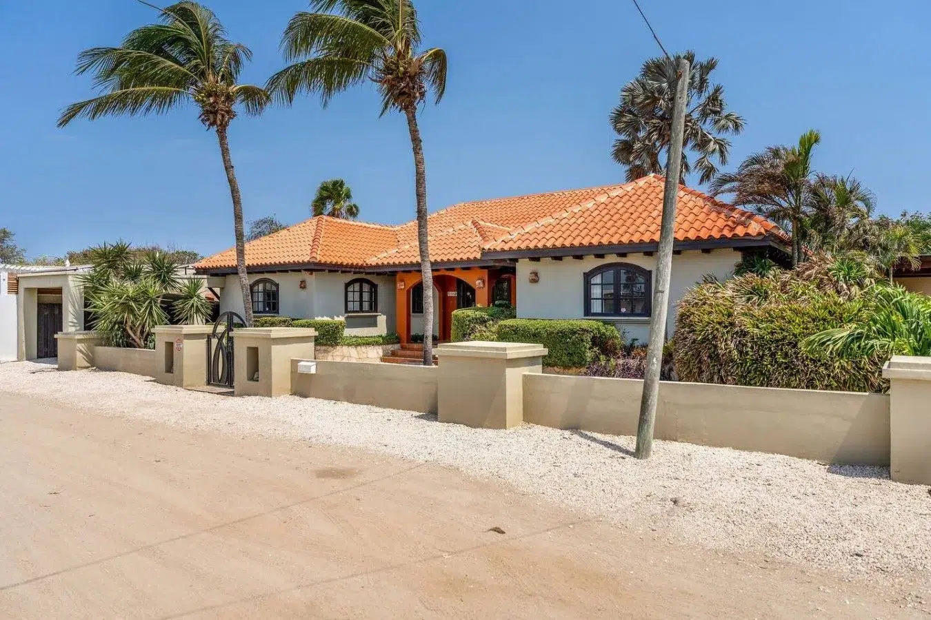 Private gated entrance of Villa Nirvana in residential Noord, Aruba