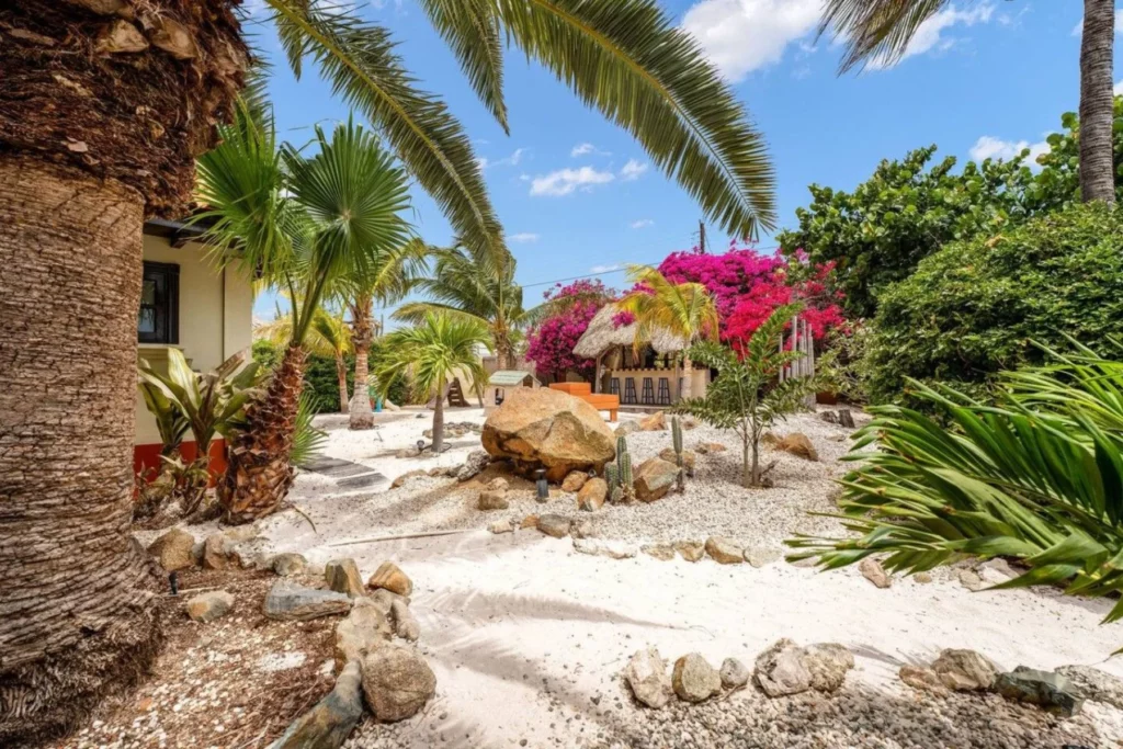 Tropical garden path with palms and flowering plants at Villa Nirvana